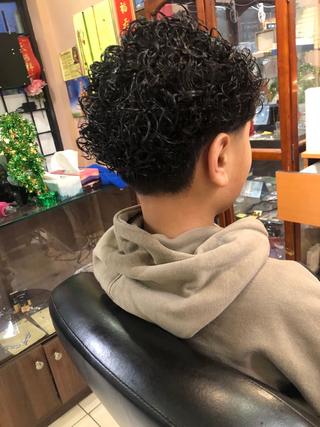Curly fade haircut, back view
