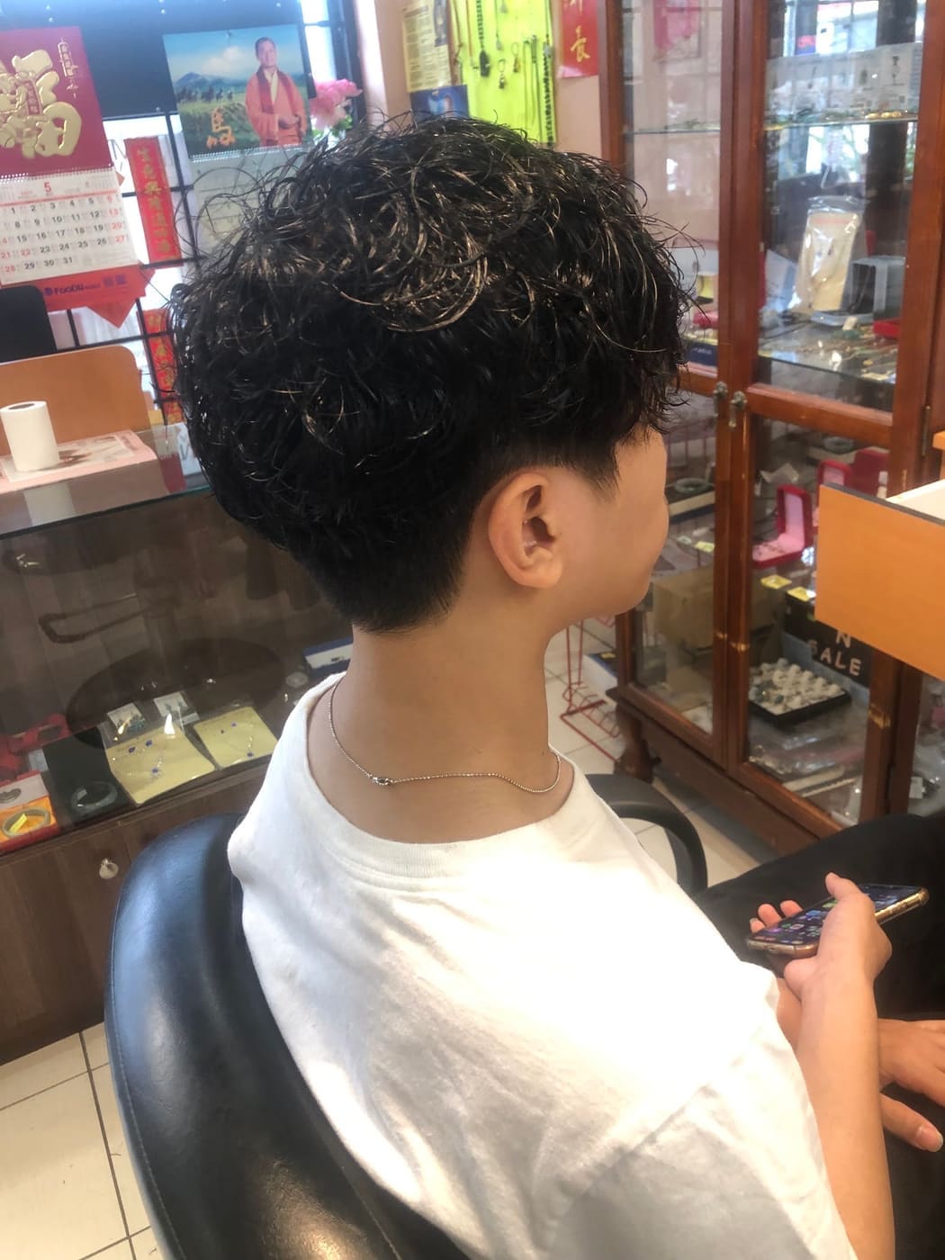 Textured curly haircut, side profile